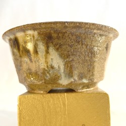 Small handmade round accent bonsai pot with rustic vertical faceted texture and matte green-brown glaze