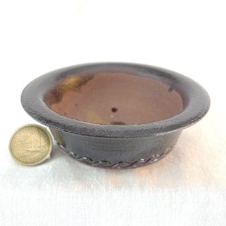 Small round accent bonsai pot with lip, deep black stoneware with red tints and wave pattern engraving