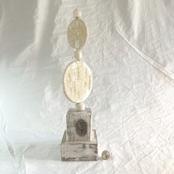 Handcrafted abstract ceramic spiral sculpture on a wooden base.