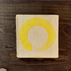 Ceramic relief featuring a thick yellow-gold Zen Ensō stroke on wood by Ismael Garcia Burillo